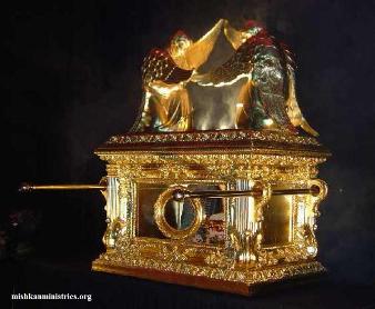 A picture of the golden Ark of the Covenant and its Mercy Seat lip adorned by two four winged Cherubim.